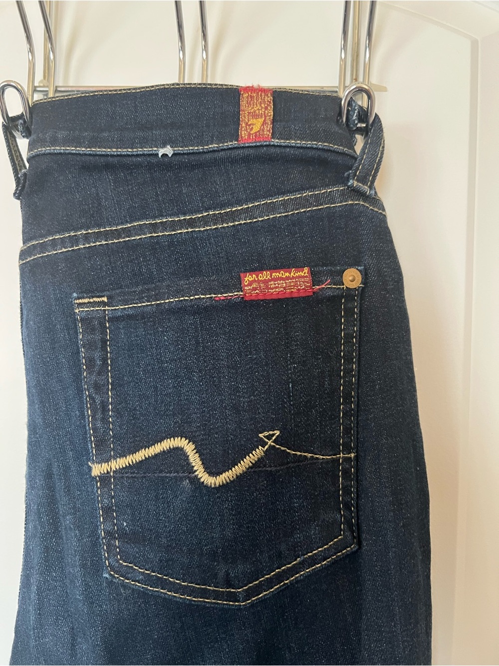 7 For All Mankind dark indigo jeans with yellow stitching